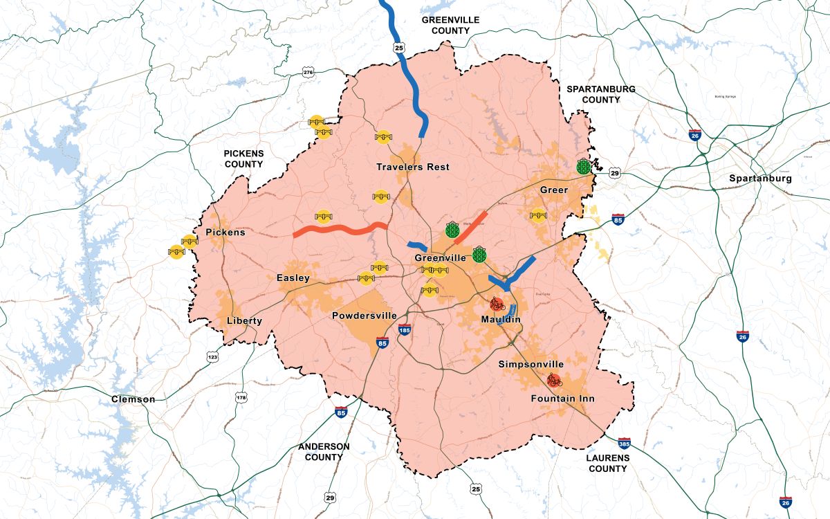 
												Map of the Greenville-Pickens Area Transportation Study (GPATS) region in South Carolina highlighting transportation projects by mode. The GPATS boundary is shaded light pink with municipal boundaries shown in light orange. Blue corridors represent roadway projects, including a major north-south corridor along U.S. 25 and several segments near Greenville and Mauldin. Red corridors represent transit improvements extending west of Greenville and northeast toward Greer. Yellow bus icons mark transit-related project locations across the region. Green traffic signal icons identify intersection improvement locations around Greenville and Greer. A bicycle icon south of Simpsonville marks a bicycle or pedestrian project. Major communities shown include Greenville, Greer, Travelers Rest, Pickens, Easley, Liberty, Powdersville, Mauldin, Simpsonville, and Fountain Inn, with surrounding counties labeled. Major highways including I-85, I-185, I-385, and U.S. 25 are also shown.
												